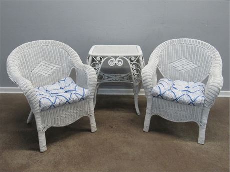 2 White Wicker Chairs with Cushions and a Side Table