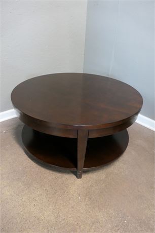 Dark Wood Round Cocktail Table on casters